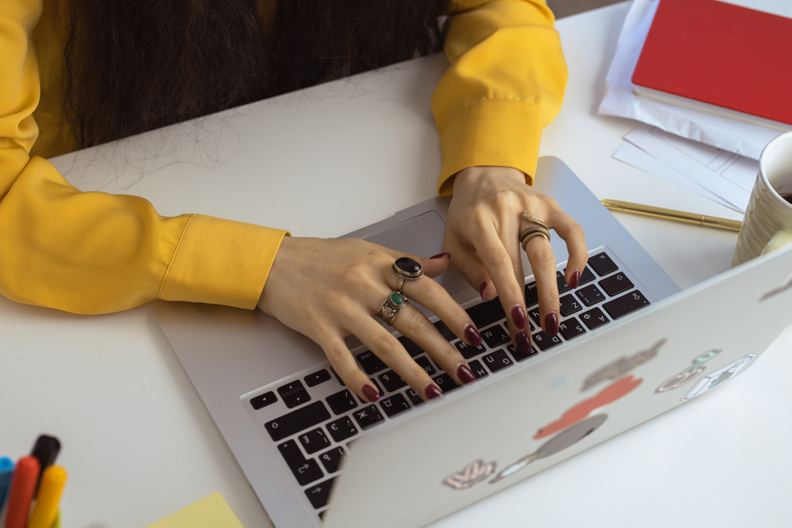 Woman in Yellow Long Sleeve Typing on Laptop 