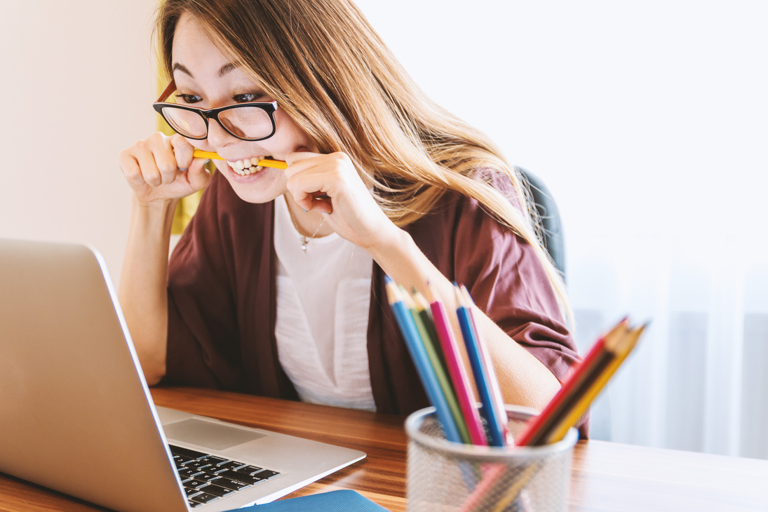 Woman Biting Pencil while Working